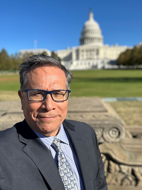 Victor standing in front of Capitol